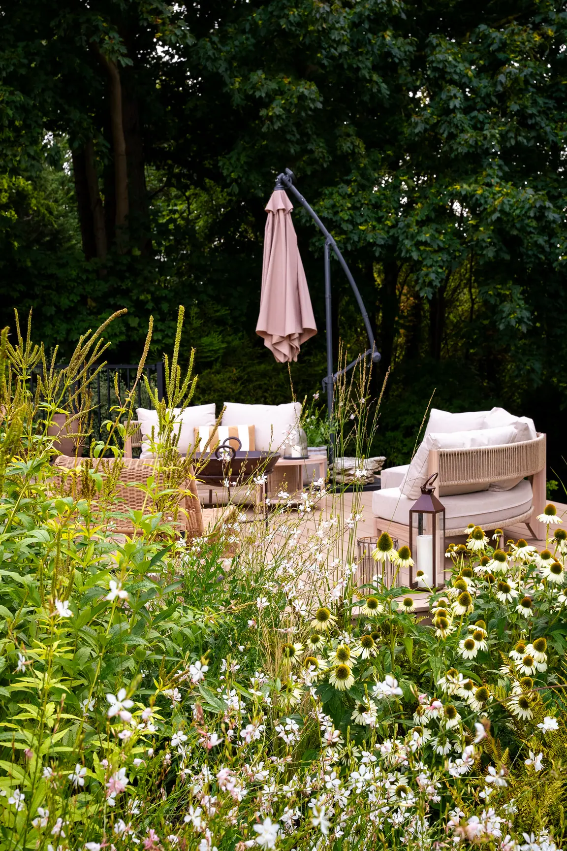 Seating on a Trex Transcend Lineage deck in Carmel, seen through flowering plants