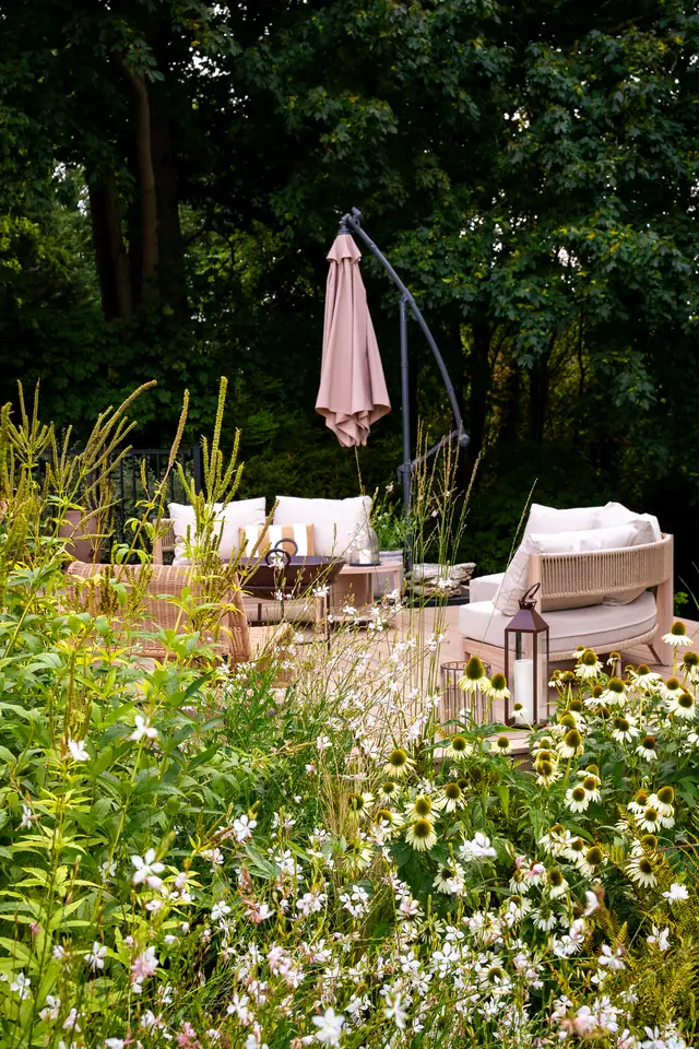 Seating on a Trex Transcend Lineage deck in Carmel, seen through flowering plants