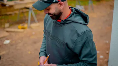 Darren marking a cut with a pencil