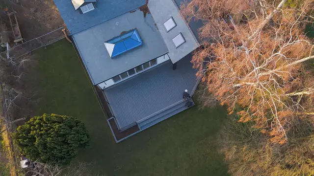An aerial view of a house and its grey Trex Transcend deck