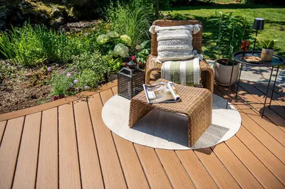 A lounge chair and footstool on a warm brown Trex Signature deck